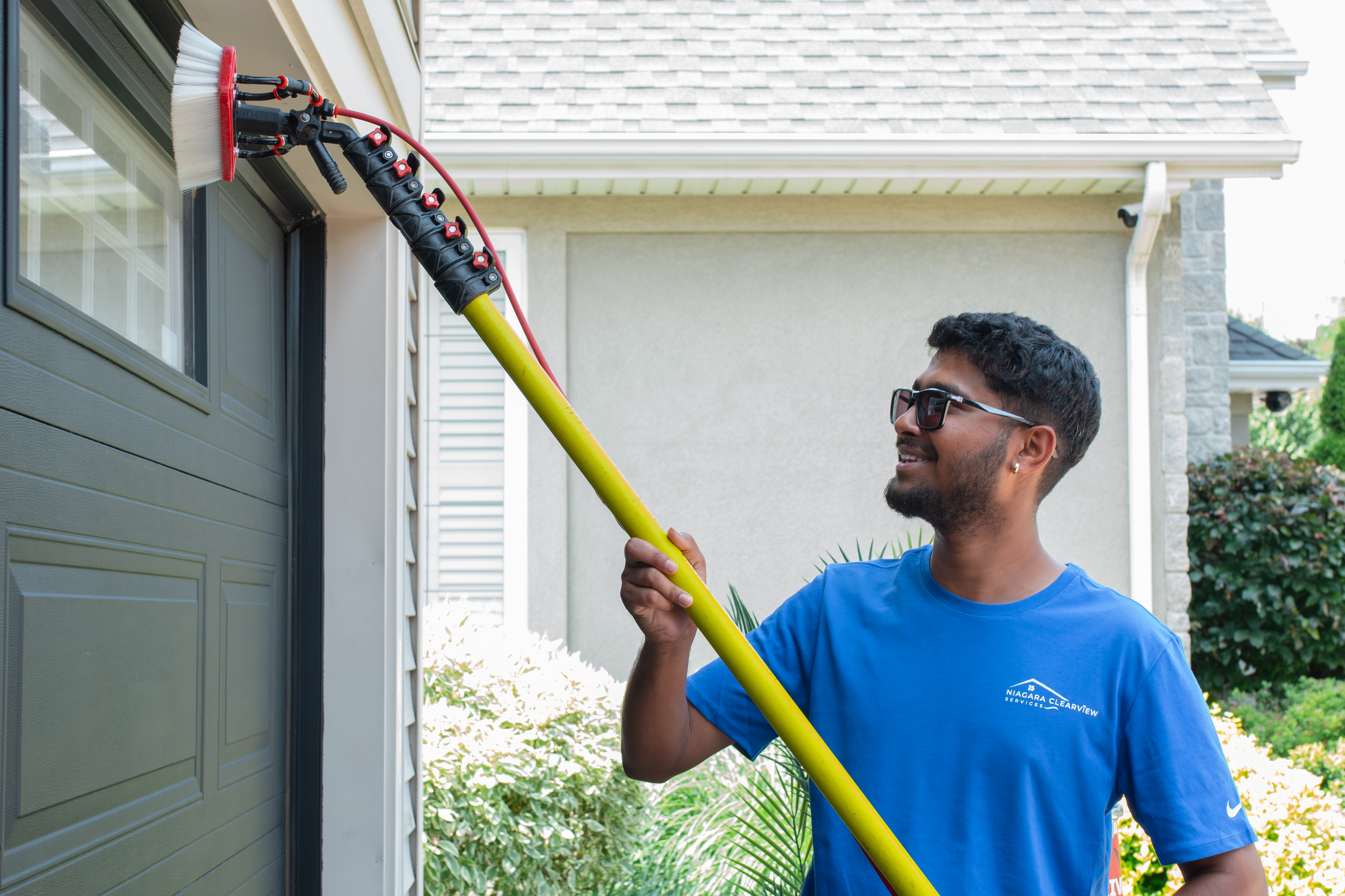ClearView technician using water-fed pole on home exterior